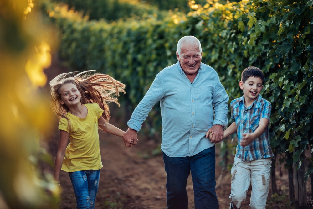 Grandfather and kids walking in an article on leaving a legacy behind by PSI World.