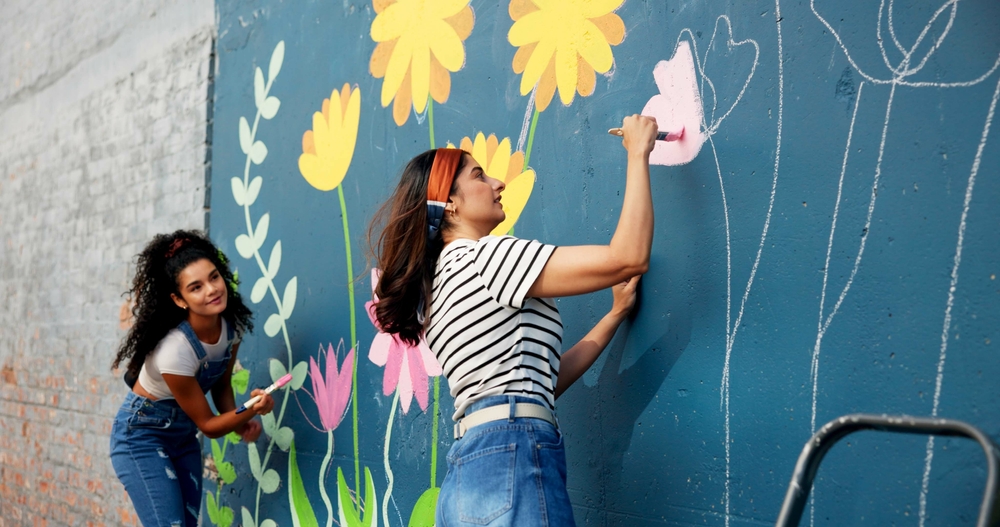 Women painting a mural in an article by PSI World on Givers Gain
